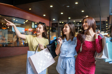 Wall Mural - Asian beautiful three women shopping goods indoors in department store. 