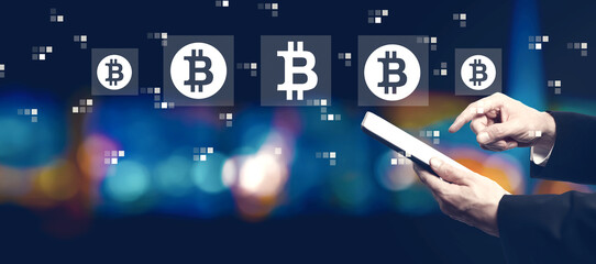 Poster - Bitcoin theme with businessman using a tablet computer at night