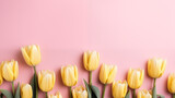 Fototapeta Tulipany - Bouquet of yellow tulips on a pink background, space for text	
