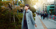 © N Felix/peopleimages.com - Woman, Asian and walking, travel or commute to work with professional in city with earphones. Listening to music on journey, podcast and commuter on urban street or sidewalk in Tokyo with playlist