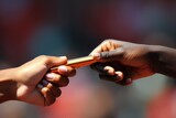 Fototapeta  - A close-up image showing one person handing an object to another person, Close-up of a baton pass in a relay race, AI Generated