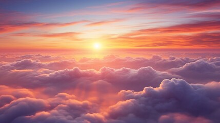 Wall Mural - aerial view of the sun setting over the clouds, creating a colorful and dramatic sky