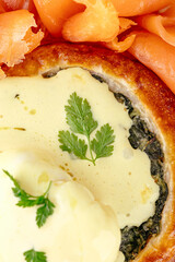 Poster - spinach bun with cheese sauce and salmon next to it on a plate