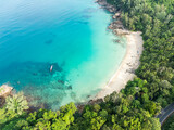 Fototapeta Do akwarium - View from above, stunning aerial view of Banana beach, a beautiful white sand beach surrounded by palm trees and bathed by a turquoise water. Phuket, Thailand.