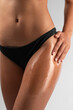 © Hihitetlin - Cropped closeup on young woman applying body oil on herself