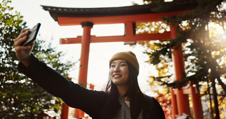 Wall Mural - Selfie, nature and Japanese woman with peace sign for holiday, vacation and adventure in Japan. Happy, travel and person take picture on smartphone for social media post, memories and online blog