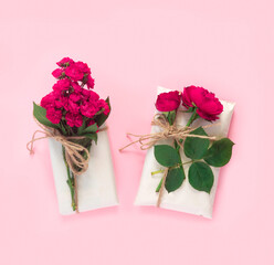 Wall Mural - Set of wrapping paper and flowers for handmade on pink background. Homemade craft box gifts with  bouquet of red roses.