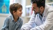 Pediatrician in white coat kneels to meet shy child's eye, offering reassuring smile.
