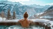 female in hot tub overlooking mountains and snow