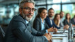 © ArtCookStudio - Suited businessman confidently presents strategic plans during a corporate meeting, exuding professionalism