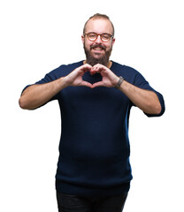 Sticker - Young caucasian hipster man wearing sunglasses over isolated background smiling in love showing heart symbol and shape with hands. Romantic concept.