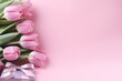 pink tulips and gifts on pink background