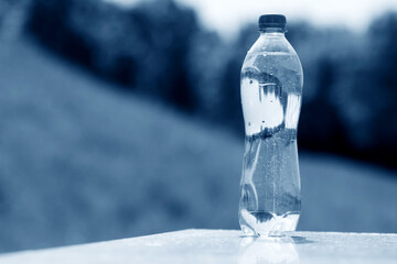 Sticker - A bottle of pure water on water background