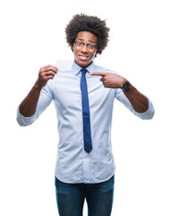 Sticker - Afro american man holding visit card over isolated background very happy pointing with hand and finger