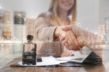 Wall Mural - Partnership, cooperation, collaboration. Double exposure of night cityscape and people shaking hands