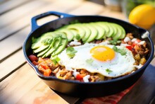 Carnitas And Egg Breakfast Skillet With Sliced Avocado