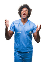 Sticker - Afro american surgeon doctor man over isolated background crazy and mad shouting and yelling with aggressive expression and arms raised. Frustration concept.