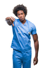 Canvas Print - Afro american surgeon doctor man over isolated background looking unhappy and angry showing rejection and negative with thumbs down gesture. Bad expression.