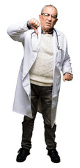 Canvas Print - Handsome senior doctor man wearing medical coat looking unhappy and angry showing rejection and negative with thumbs down gesture. Bad expression.