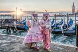 Fototapeta Big Ben - Colorful carnival masks at a traditional festival in Venice against gondolas, Italy