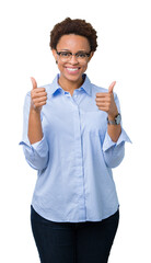 Sticker - Young beautiful african american business woman over isolated background success sign doing positive gesture with hand, thumbs up smiling and happy. Looking at the camera.