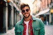 Portrait of a handsome young man in sunglasses smiling at the camera