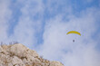 Paraglider flying over the sea coast in blue sky background