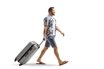 Canvas Print - Man in flip-flops pulling a suitcase smiling and walking