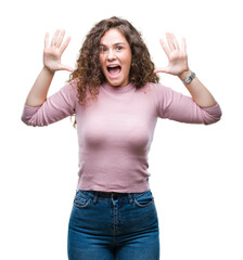 Canvas Print - Beautiful brunette curly hair young girl wearing pink sweater over isolated background showing and pointing up with fingers number ten while smiling confident and happy.