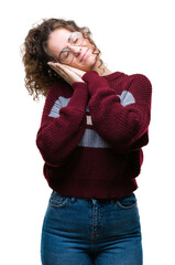 Wall Mural - Beautiful brunette curly hair young girl wearing glasses over isolated background sleeping tired dreaming and posing with hands together while smiling with closed eyes.