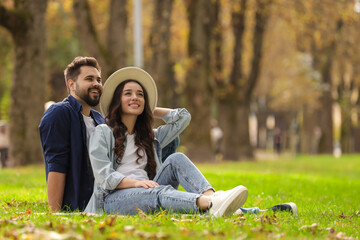 Poster - Beautiful couple spending time together in park. Space for text