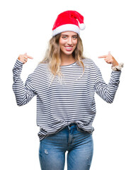 Sticker - Beautiful young blonde woman wearing christmas hat over isolated background looking confident with smile on face, pointing oneself with fingers proud and happy.