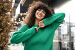 © New Africa - Happy young woman in stylish green sweater outdoors