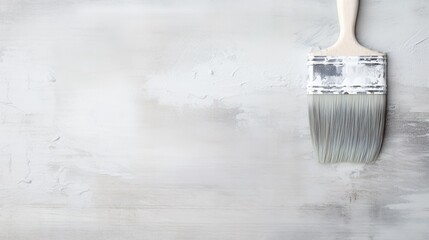 Wall Mural - Paintbrush with white bristles, stained with paint against a partially painted textured white wall. Painting tutorials, Home renovation, Artistic inspiration concept.