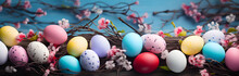 Multicolored Painted Easter Eggs And Dried Twigs On A Blue Background

