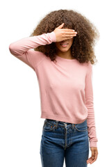 Canvas Print - African american woman wearing pink sunglasses smiling and laughing with hand on face covering eyes for surprise. Blind concept.