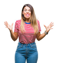 Sticker - Young beautiful woman casual look over isolated background crazy and mad shouting and yelling with aggressive expression and arms raised. Frustration concept.