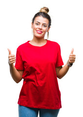 Wall Mural - Young beautiful woman over isolated background success sign doing positive gesture with hand, thumbs up smiling and happy. Looking at the camera with cheerful expression, winner gesture.