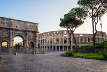 Amazing Panoramic View Of Arch Of Constantine (Arco Di Constantino) And Colosseum At Beautiful Warm Light After Sunrise, Rome, Italy..