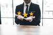 Businessman Close up on Customer Man hand with golden five star feedback icon and excellent rating for best rating in business concept service review