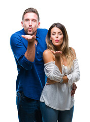 Canvas Print - Young couple in love over isolated background looking at the camera blowing a kiss with hand on air being lovely and sexy. Love expression.