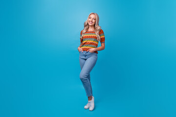 Wall Mural - Full length photo of cute dreamy girl dressed print shirt looking empty space isolated blue color background