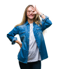 Sticker - Young beautiful blonde woman wearing glasses over isolated background doing ok gesture with hand smiling, eye looking through fingers with happy face.