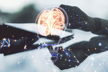 Poster - Creative light bulb with human brain hologram and hand working with a digital tablet on background, artificial Intelligence and neural networks concept. Multiexposure