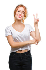 Sticker - Young beautiful woman over isolated background smiling with happy face winking at the camera doing victory sign. Number two.