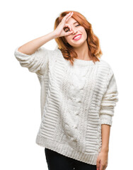 Sticker - Young beautiful woman over isolated background wearing winter sweater doing ok gesture with hand smiling, eye looking through fingers with happy face.