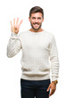 © Krakenimages.com - Young handsome man wearing winter sweater over isolated background showing and pointing up with fingers number four while smiling confident and happy.