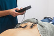 © ADDICTIVE STOCK - Medical Professional Attaching ECG Electrodes to Patient