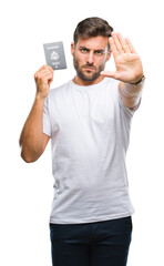 Sticker - Young handsome man holding passport of united states over isolated background with open hand doing stop sign with serious and confident expression, defense gesture