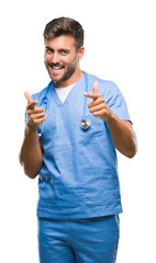 Sticker - Young handsome doctor surgeon man over isolated background pointing fingers to camera with happy and funny face. Good energy and vibes.